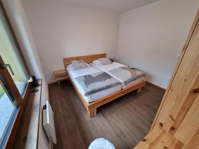 a bedroom with a bed in the corner of a room at Luna's Mountain House - Jezersko in Zgornje Jezersko