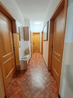 a hallway with two doors and a tiled floor at Apartma Pohorc - Kostanj in Pohorje
