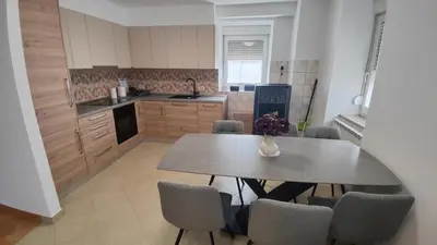 a kitchen with a table and chairs in it at Frane House in Knežak