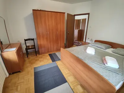 a large bedroom with two beds and a dresser at Frane House in Knežak