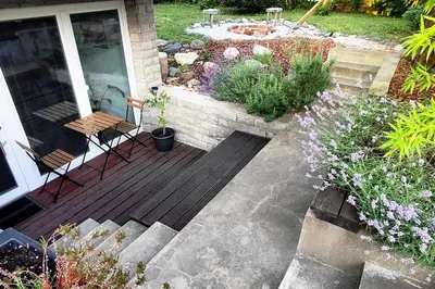 a porch with a wooden deck with chairs and plants at Rustikal Apartment with Garden and Free Parking in Ljubljana