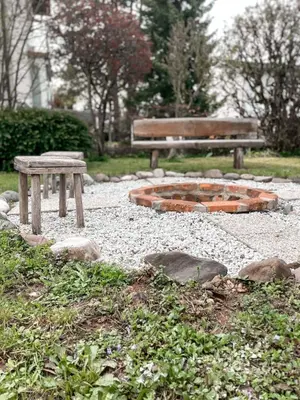 two benches and a fire pit in a park at Rustikal Apartment with Garden and Free Parking in Ljubljana