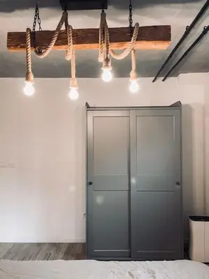 a room with a door and lights on the wall at Rustikal Apartment with Garden and Free Parking in Ljubljana