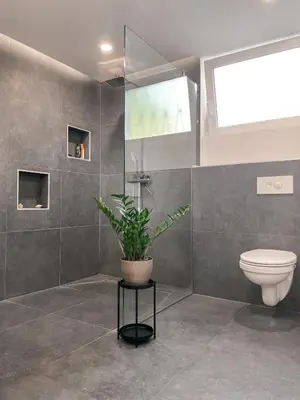 a bathroom with a toilet and a potted plant at Rustikal Apartment with Garden and Free Parking in Ljubljana