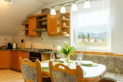 a kitchen with a table and a dining room at Apartment in the Village in Petrovče
