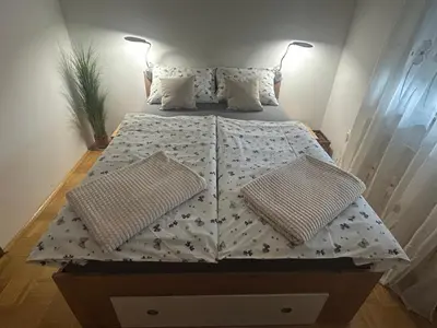 a bed with two pillows on it in a room at Apartment in the Village in Petrovče