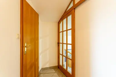 a hallway with a door and a window at Apartment in the Village in Petrovče