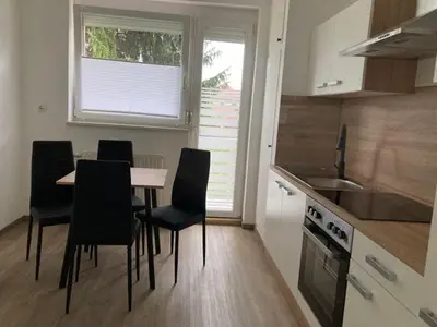 a kitchen with a table and chairs in a room at Nice apartment in Celje in Celje