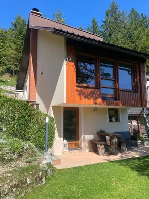 a house with a large window on the side of it at Počitniška hiša Lily in Idrija