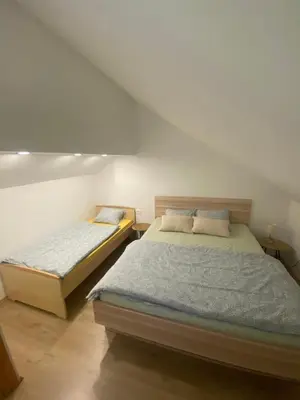 a bedroom with two beds in a room at Počitniška hiša Lily in Idrija