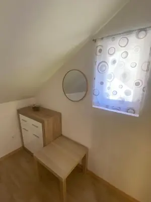 a small room with a table and a mirror at Počitniška hiša Lily in Idrija