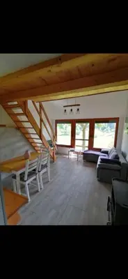 a large living room with a couch and chairs at Počitniška hiša Lily in Idrija