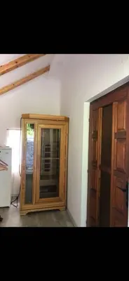 a room with a wooden cabinet next to a door at Počitniška hiša Lily in Idrija