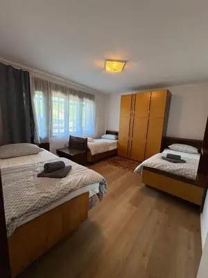 a bedroom with two beds and a room with twoperate beds at Suzi Apartments in Lokev
