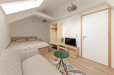 a bedroom with a bed and a green table at House Pr'Španc in Ljubljana