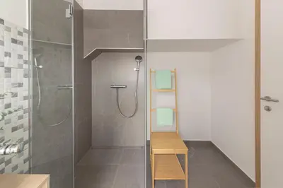 a shower with a glass door in a bathroom at House Pr'Španc in Ljubljana
