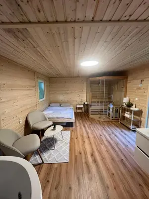 a room with a bed and chairs in a room at Glamping - domačija Lamperček in Velenje