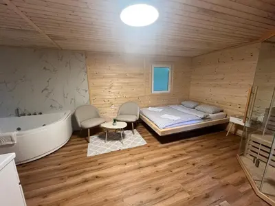 a bedroom with a bed and a bathtub and a tub at Glamping - domačija Lamperček in Velenje