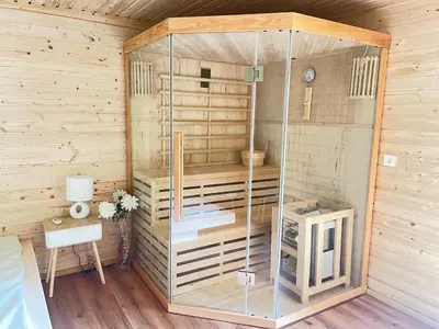 a sauna with a glass enclosure and a table at Glamping - domačija Lamperček in Velenje