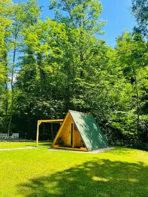 a small building in a field with a goal at Glamping - domačija Lamperček in Velenje