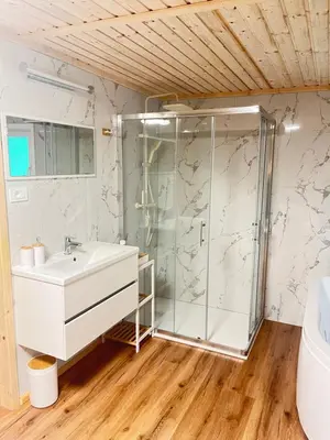 a bathroom with a shower and a sink at Glamping - domačija Lamperček in Velenje