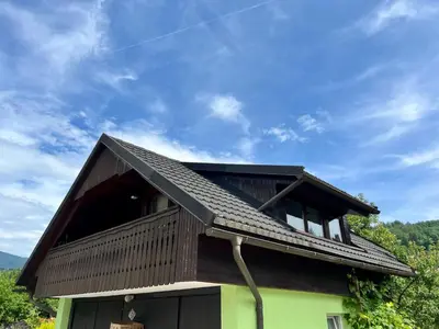 a house with a gambrel roof on top of it at Studio Lilly in Bohinj