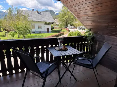 a patio with two chairs and a table on a balcony at Studio Lilly in Bohinj