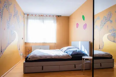 a bedroom with a bed and a window at The Color Loft in Ljubljana