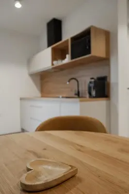 a wooden spoon sitting on top of a wooden table at LJ Apartments - Šempeter pri Gorici in Šempeter pri Gorici