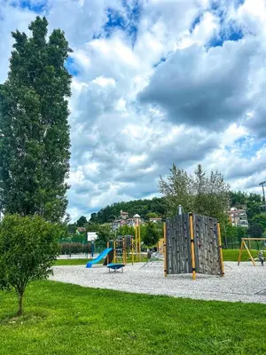 a park with a playground with a tree at LJ Apartments - Šempeter pri Gorici in Šempeter pri Gorici