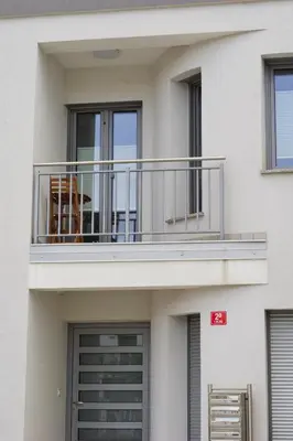 a building with a balcony with a dog on it at LJ Apartments - Šempeter pri Gorici in Šempeter pri Gorici