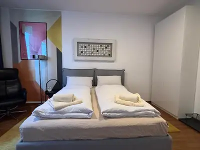 a bedroom with a bed with two pillows on it at Rosa & Nora Apartments in Ljubljana