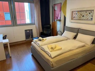 a bedroom with two beds with yellow towels on them at Rosa & Nora Apartments in Ljubljana