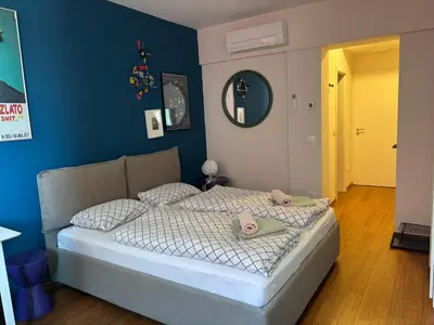 a bedroom with a bed with two stuffed animals on it at Rosa & Nora Apartments in Ljubljana
