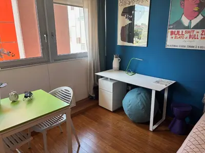 a small room with a desk and a table at Rosa & Nora Apartments in Ljubljana