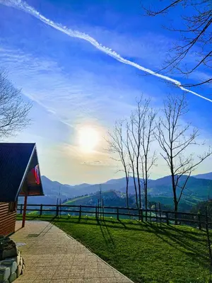 a view of the mountains with the sun in the sky at Hiška pod krošnjami