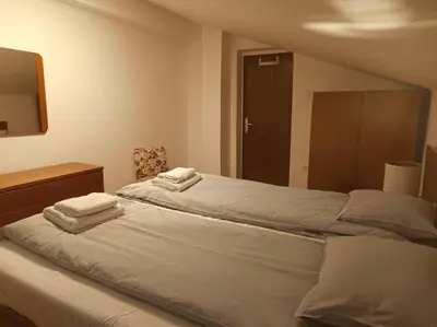 a bedroom with a bed with two towels on it at Green view apartment in Sežana