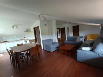 a living room with a couch and a table at Green view apartment in Sežana