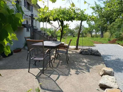 a table and chairs sitting on a patio at Green view apartment in Sežana