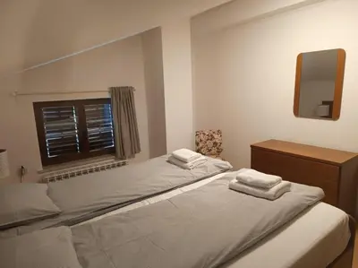 a bedroom with a bed with two towels on it at Green view apartment in Sežana