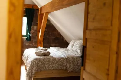 a bedroom with a bed with two towels on it at Golavškov mlin - Eco Heritage Boutique Stay in Prebold