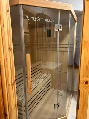 a glass display case in a wooden cabinet at Golavškov mlin - Eco Heritage Boutique Stay in Prebold
