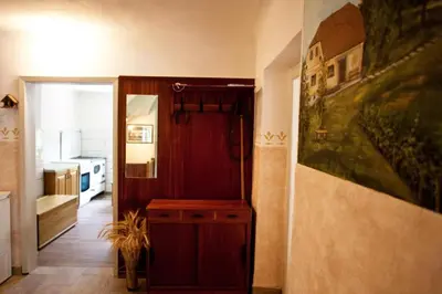 a room with a hallway with a door to a kitchen at Počitniška hiša pod RAJHOVKO in Ljubno