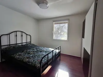 a bedroom with a bed and a window at Hiša Terra in Volzana
