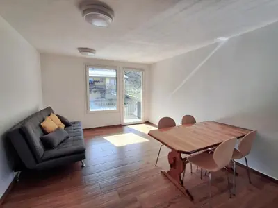 a living room with a wooden table and a couch at Hiša Terra in Volzana