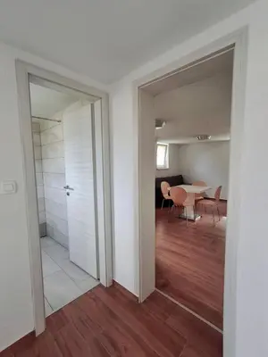 a room with a door and a table and chairs at Hiša Terra in Volzana