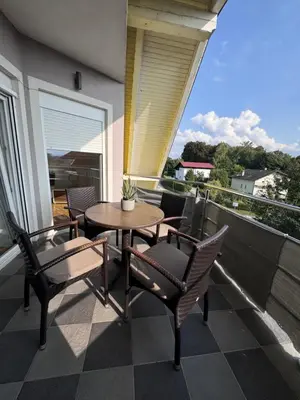 a patio with a table and chairs on a balcony at Rezidenca Vista Lux in Ptuj