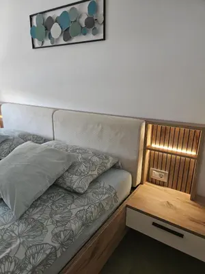 a couch in a room with a side table at Apartma VINT in Ajdovščina