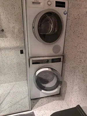 a washing machine and a washer in a bathroom at Enchanting appartment Eipprova in Ljubljana