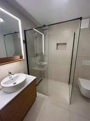 a bathroom with a sink and a glass shower at Natura in Radovljica